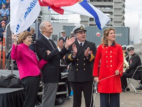 Sophie Gregoire Trudeau, right, releases a bottle of Nova Scotia sparkling wine with James DeWolf, son of the late Harry DeWolf, as his wife Michelle DeWolf, left, and Cmdr. Corey Gleeson look on at the naming ceremony for Canada's lead Arctic and Offshore Patrol Ship, the future HMCS Harry DeWolf, in Halifax on Friday, Oct. 5, 2018.