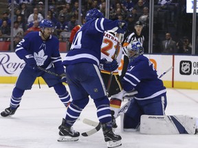 Maple Leafs defencemen Ron Hainsey (left) and Morgan Rielly look for the puck in front of goalie Frederik Andersen in a 3-1 loss to the Calgary Flames on Monday. (Jack Boland/Toronto Sun)