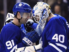 Toronto Maple Leafs centre John Tavares (91) and goaltender Garret Sparks (40) celebrate after defeating the Los Angeles Kings in NHL hockey action in Toronto on Monday, October 15, 2018.