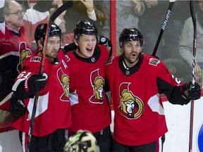 Ottawa Senators left wing Brady Tkachuk (centre) celebrates his goal with teammates right wing Mark Stone, left, and defenceman Dylan DeMelo as Dallas Stars goaltender Ben Bishop stands in his crease during third period NHL action Monday October 15, 2018 in Ottawa.