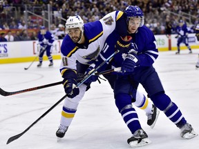 St. Louis Blues’ Robert Bortuzzo (left) gets an elbow up on Maple Leafs’ Zach Hyman on Saturday night in Toronto. (FRANK GUNN/THE CANADIAN PRESS)