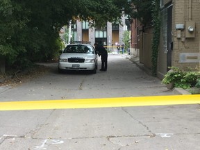 Police cordon off an alley near Saulter and Queen Sts. for a suspicious death investigation on Fri., Oct. 5, 2018.