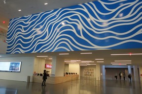 Artist Sol LeWitt’s mural Wall Drawing 895: Loopy Doopy, consisting of blue and white wavy lines, hangs over the lobby in SanFrancisco Museum of Modern Art, 151 Third St. (Ian Robertson photo)