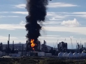 A fire and plume of smoke rises from an Irving Oil refinery following reports of an explosion in Saint John, N.B., on Monday, October 8, 2018. Irving Oil says a "major incident" happened at its oil refinery in Saint John, N.B., this morning. THE CANADIAN PRESS/HO - Nate Guimond