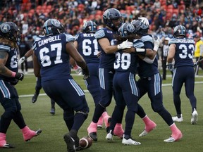 Argonauts players celebrate James Franklin's (2) touchdown during first half CFL action against the Alouettes, in Toronto, Saturday, Oct. 20, 2018.