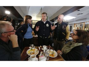 Toronto mayor John Tory out campaigning in the Beach area at the Beaches cafe on Queen St. East with current city councillor Mary-Margaret McMahon and potential newcomer Brad Bradford on Saturday, Oct. 20, 2018. (Jack Boland/Toronto Sun/Postmedia Network)