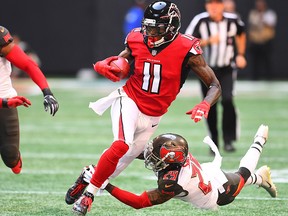 Julio Jones of the Atlanta Falcons is tackled by Ryan Smith of the Tampa Bay Buccaneers during the first quarter against the Tampa Bay Buccaneers at Mercedes-Benz Stadium on Oct. 14, 2018 in Atlanta, Ga.