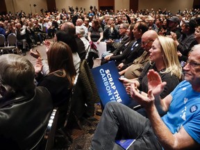 Supporters cheer at an anti-carbon tax rally in Calgary, Friday, Oct. 5, 2018.