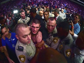 Khabib Nurmagomedov is escorted out of the arena after defeating Conor McGregor in their UFC lightweight championship bout during UFC 229 in T-Mobile Arena on October 6, 2018 in Las Vegas. (Harry How/Getty Images)