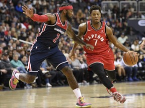 Raptors guard Kyle Lowry (7) dribbles the ball against Wizards guard John Wall (2) during first half NBA action in Washington, Saturday, Oct. 20, 2018.