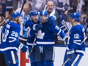 Maple Leafs centre Auston Matthews (34) celebrates the game-winning goal with teammates Morgan Rielly (44) Patrick Marleau (12) and Connor Brown (28) during overtime against the Montreal Canadiens in Toronto on Wednesday, Oct. 3, 2018. (NATHAN DENETTE/THE CANADIAN PRESS)
