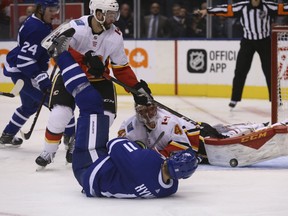 Toronto Maple Leafs Zach Hyman C (11) tries to swat the puck out of the air in front of Calgary Flames Mike Smith G (41) during the third period in Toronto on Tuesday October 30, 2018. (Jack Boland/Toronto Sun/Postmedia Network)