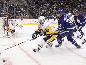Penguins' Phil Kesse spins away from the Maple Leafs' Auston Matthews on Thursday night. (Jack Boland/Toronto Sun/Postmedia Network)