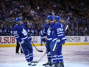 Maple Leafs’ Josh Leivo (left) celebrates during a pre-season game against the Buffalo Sabres on Sept. 21. Leivo will make his opening-night debut with the Leafs on Wednesday. (JACK BOLAND/TORONTO SUN)