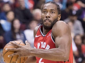 Newcomer Kawhi Leonard has been on the floor with Kyle Lowry throughout the Raptors training camp. (Jonathan Hayward/The Canadian Press)