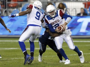 The Argos wrap up Alouettes quarterback Johnny Manziel during the second half of their game on Saturday, Oct. 20. (Cole Burston/The Canadian Press)