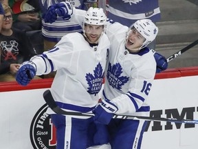Toronto Maple Leafs John Tavares (91) celebrates with Mitch Marner (16) after scoring against the Chicago Blackhawks during the third period of an NHL hockey game Sunday, Oct. 7, 2018, in Chicago. (AP Photo/Kamil Krzaczynski)