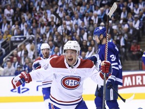 Montreal Canadiens left wing Max Domi (13) celebrates a goal by teammate Artturi Lehkonen against the Toronto Maple Leafs during first period NHL hockey action in Toronto on Wednesday, October 3, 2018. (NATHAN DENETTE/THE CANADIAN PRESS)