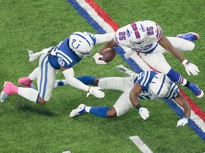 Buffalo Bills running back LeSean McCoy is tackled by Indianapolis Colts cornerback Kenny Moore and linebacker Anthony Walker during the first half of an NFL football game in Indianapolis, Sunday, Oct. 21, 2018.