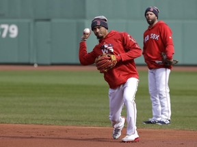 Red Sox's Mookie Betts works out at second base with Dustin Pedroia watching at Fenway Park in Boston, Sunday, Oct. 21, 2018.