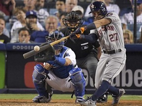 In this Oct. 25, 2017, file photo, Houston Astros' Jose Altuve hits a home run against the Los Angeles Dodgers during the 10th inning of Game 2 of baseball's World Series in Los Angeles.