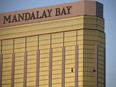 In this Oct. 2, 2017, file photo, drapes billow out of broken windows at the Mandalay Bay resort and casino on the Las Vegas Strip, following a deadly shooting at a music festival in Las Vegas.