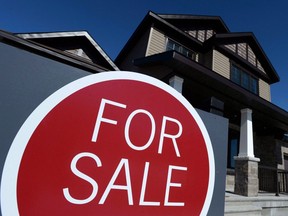 A sign advertises a new home for sale in Carleton Place, Ont., on March 17, 2015.  THE CANADIAN PRESS/Sean Kilpatrick