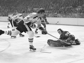 Los Angeles Kings' goalie Rogatien Vachon drop his stick but holds on to the puck as Boston Bruins' Bobby Orr (4) tries to score in the second period at the Boston Gardens, Jan. 13, 1972. (CP FILES)
