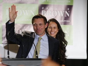 Newly-elected Brampton mayor Patrick Brown, joined by wife Genevieve, waves to supporters after his election win Monday night.  (Jack Boland/Toronto Sun)