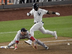 Boston Red Sox first baseman Steve Pearce stretches for the throw ahead of New York Yankees' Gleyber Torres for the final out of Game 4 of the  American League Division Series, Tuesday, Oct. 9, 2018, in New York. (AP Photo/Bill Kostroun)