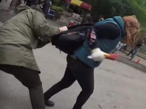 A screengrab of a YouTube video of a pro-choice activist allegedly assaulting a pro-life activist at Ryerson University on Oct. 1.