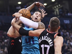 Charlotte Hornets Willy Hernangomez (centre) is fouled by Raptors’ C.J. Miles (left), as Raps’ Jonas Valanciunas defends during Monday’s game in Toronto. Valanciunas racked up 17 points and 10 boards coming off the bench. (THE CANADIAN PRESS/PHOTO)