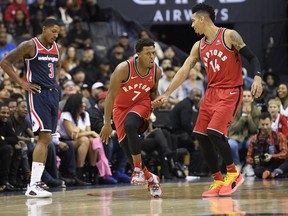 Toronto Raptors guard Kyle Lowry (7) reacts with guard Danny Green (14) after he made a three-point basket during the second half of an NBA basketball game as Washington Wizards guard Bradley Beal stands at left, Saturday, Oct. 20, 2018, in Washington. The Raptors won 117-113. (AP Photo/Nick Wass) ORG XMIT: VZN112