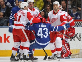 Red Wings centre Luke Glendening left) flattens Maple Leafs forward Nazem Kadri in a game from last season. GETTY IMAGES FILE