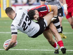 Toronto Wolfpack forward Nick Rawsthorne (23) gets tackled by London Broncos Rhys Williams, right, during first half rugby league action in Toronto on Sunday, October 7, 2018.