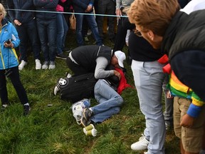 Corine Remande lies injured on the ground after being struck by a wayward shot the Ryder Cup. She has lost vision in her right eye and is planning on suing organizers.