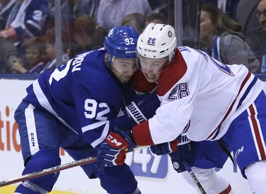Toronto Maple Leafs Igor Ozhiganov D (92) goes cheek to cheek with Montreal Canadiens Mike Reilly D (28)during the second period in Toronto on Thursday October 4, 2018. Jack Boland/Toronto Sun/Postmedia Network