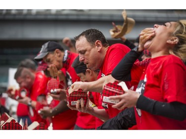 Joey Chestnut (middle) who is reported to be the #1-ranked professional eaterÊin the world and also finished in 1st place at Toronto'sÊ9th Annual SmokeÕs Poutinerie World Poutine Eating Championship Yonge-Dundas Square in Toronto, Ont. on Saturday October 13, 2018. Ernest Doroszuk/Toronto Sun/Postmedia