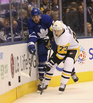 Pittsburgh Penguins Jack Johnson D (73) knocks Toronto Maple Leafs Frederik Gauthier C (33) off the puck during the first period in Toronto on Thursday October 18, 2018. Jack Boland/Toronto Sun/Postmedia Network