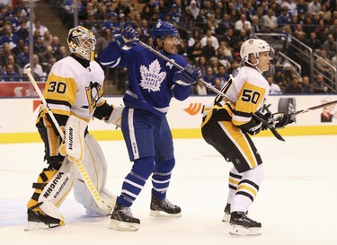 Pittsburgh Penguins Juuso Riikola D (50) holds the stick of Toronto Maple Leafs Patrick Marleau C (12) in front of goalie Matt Murray G (30) during the first period in Toronto on Thursday October 18, 2018. Jack Boland/Toronto Sun/Postmedia Network