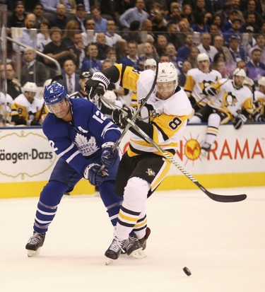 Toronto Maple Leafs Patrick Marleau C (12) and Pittsburgh Penguins Brian Dumoulin  D (8) jostle inside the blue line during the first period in Toronto on Thursday October 18, 2018. Jack Boland/Toronto Sun/Postmedia Network