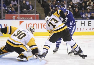 Toronto Maple Leafs Patrick Marleau C (12) and Pittsburgh Penguins Jack Johnson D (73) fight for the bouncing puck during the third period in Toronto on Thursday October 18, 2018. Jack Boland/Toronto Sun/Postmedia Network