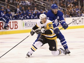 Maple Leafs Patrick Marleau C (12) ties up Pittsburgh Penguins Sidney Crosby C (87) during the second period in Toronto on Thursday, Oct. 18, 2018. (Jack Boland/Toronto Sun/Postmedia Network)