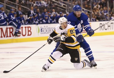 Toronto Maple Leafs Patrick Marleau C (12) ties up Pittsburgh Penguins Sidney Crosby C (87) during the second period in Toronto on Thursday October 18, 2018. Jack Boland/Toronto Sun/Postmedia Network