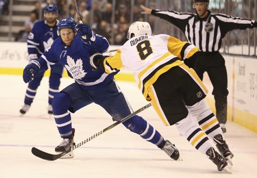 Pittsburgh Penguins Brian Dumoulin  D (8) slows up Toronto Maple Leafs Par Lindholm C (26) during the third period in Toronto on Thursday October 18, 2018. Jack Boland/Toronto Sun/Postmedia Network