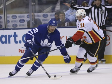 Calgary Flames Mikael Backlund  C (11) checks Toronto Maple Leafs Andreas Johnsson LW (18) during the first period in Toronto on Monday October 29, 2018. Jack Boland/Toronto Sun/Postmedia Network