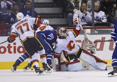 Toronto Maple Leafs Frederik Gauthier C (33) collides with Calgary Flames Mike Smith G (41) during the second period in Toronto on Tuesday October 30, 2018. Jack Boland/Toronto Sun/Postmedia Network