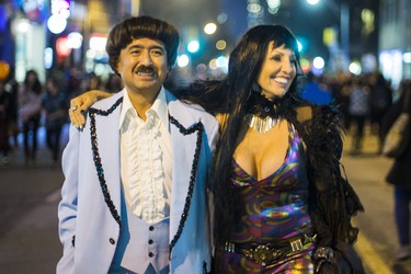 Joel Natareno and Lena Kovacs channeling Sonny and Cher as Halloween comes to the Village as a part of Church St. is closed to traffic for Halloween on Church in Toronto, Ont. on Wednesday October 31, 2018. Ernest Doroszuk/Toronto Sun/Postmedia