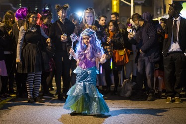 Stella McDiarmid Great, 5, dressed as Ariel, enjoying music played by CIUT 89.5 FM from their booth as Halloween comes to the Village as a part of Church St. is closed to traffic for Halloween on Church in Toronto, Ont. on Wednesday October 31, 2018. Ernest Doroszuk/Toronto Sun/Postmedia