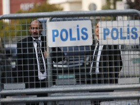 Security personnel guarding Saudi Arabia's consulate are seen behind barriers blocking the road leading to the diplomatic mission, in Istanbul, Monday, Oct. 22, 2018. Saudi Crown Prince Mohammed bin Salman called the son of Jamal Khashoggi, the kingdom announced early Monday, to express condolences for the death of the journalist killed at the Saudi Consulate in Istanbul by officials that allegedly included a member of the royal's entourage.